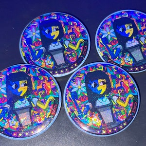 May include: Four round, colorful, glittery buttons with a cartoon character design. The character is a girl with blue and yellow hair, wearing a white shirt and a black skirt. The background is a psychedelic pattern of colorful shapes and swirls.