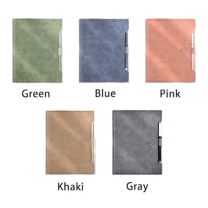 May include: Six different coloured leather-bound journals with a gold pen attached to each. The colours are green, blue, pink, khaki, and grey.