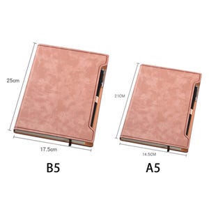 May include: Two pink leather-bound notebooks with pen holders. The larger notebook is labeled "B5" and measures 17.5 inches by 25 inches. The smaller notebook is labeled "A5" and measures 14.5 inches by 21 inches.
