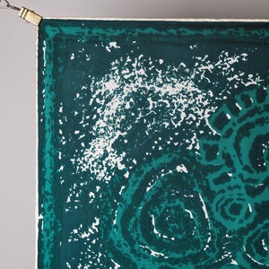 May include: A green and white patterned fabric with a white border. The fabric has a swirling pattern with white spots on a dark green background.