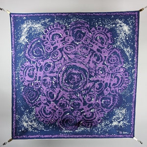 May include: A purple and blue patterned silk scarf with a swirling design. The scarf is hanging from two hooks.