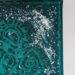 May include: A green and white patterned fabric with a white border. The fabric has a repeating pattern of circles.