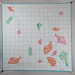 May include: White cotton square scarf with a teal grid pattern and colorful seashell designs. The seashells are in various shades of pink, red, green, and blue.