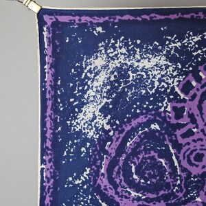 May include: A purple and blue patterned silk scarf with a white border. The scarf has a swirling design with a white background.