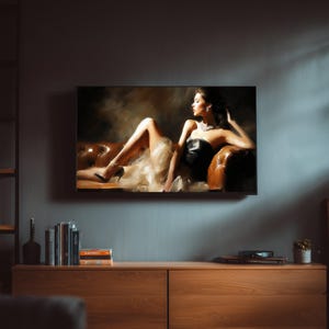 May include: A framed artwork depicts a woman in a black dress reclining on a brown leather sofa. The artwork is mounted on a gray wall above a wooden cabinet. Books and decorative items are on the cabinet.