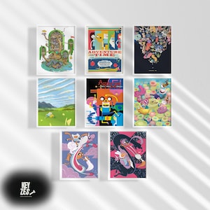 May include: A collection of nine framed art prints featuring colorful illustrations. The prints showcase various scenes and characters, with the text "ADVENTURE TIME" visible on one. The artwork is displayed against a white wall.