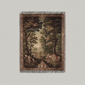 May include: Woven tapestry throw blanket featuring a classical landscape scene with figures, trees, and a building in the background. The blanket has a fringed edge and is primarily in shades of brown, green, and beige.
