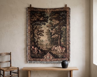 May include: A rectangular woven wall tapestry featuring a detailed landscape scene with tall trees, figures, and horses. The border is decorated with ornate scrollwork and floral motifs. The edges are finished with a fringed trim on all sides.