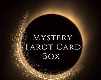 May include: A black circle with a gold ring around it. The text "MYSTERY TAROT CARD BOX" is written in white inside the circle.