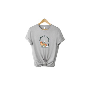May include: A gray t-shirt with a cartoon hot dog character wearing a baseball cap and holding a drink. The text "rollin' & trollin'" is printed in a circle around the character.