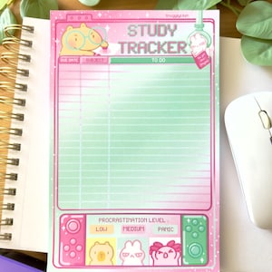 May include: A pink and green Study Tracker notepad with a cute cartoon hamster wearing glasses. The notepad has sections for due dates, subjects, and to-do lists. It also features a procrastination level indicator with cute animal illustrations.