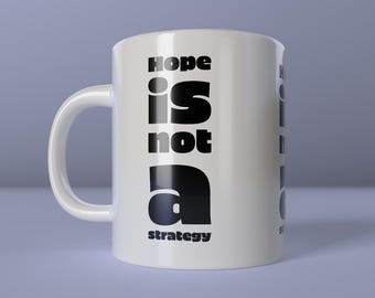 May include: White ceramic mug with the text "Hope is not a strategy" in black, bold font. The mug has a curved handle and the words "create happiness" are at the bottom.