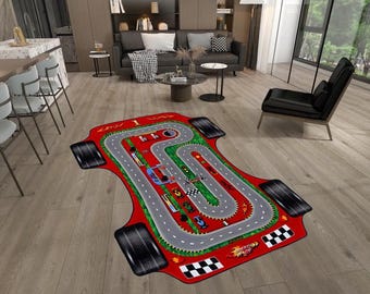 May include: A red area rug shaped like a race car featuring a printed gray racetrack with green grass, multiple colorful toy cars, a checkered finish line, and the text Speed Race, complete with four black tire graphics at the corners.
