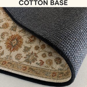 a close-up view of a textured rug or carpet with a floral pattern, resting on a surface.