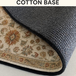 a close-up view of a textured rug or carpet with a floral pattern, resting on a surface.