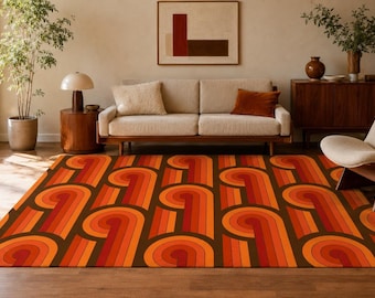 May include: A rectangular area rug featuring a repeating geometric pattern of concentric curved lines in shades of orange, red, and dark brown. The design consists of interconnected arching shapes that create a rhythmic, flowing visual effect.