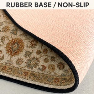 a close-up view of a rug with a textured surface, featuring a floral pattern. The rug appears to have a non-slip base, which is designed to provide stability and prevent slipping on the surface.