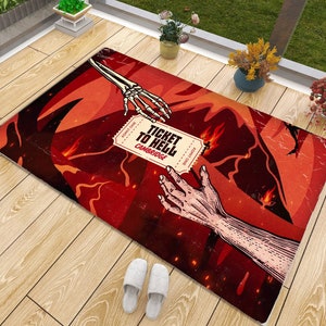 Puede incluir: Una alfombra roja y negra con una mano esquelética que se extiende para agarrar un boleto que dice "Ticket to Hell, Cambridge". El boleto está roto y tiene llamas detrás.