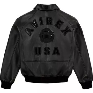 May include: Black leather jacket with the word "AVIREX" arched across the shoulders and "USA" below a circular emblem. The jacket has a ribbed hem and cuffs, and a classic collar.
