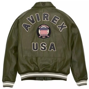 May include: Olive green leather jacket with the word "AVIREX" across the back in white lettering. A patch with the American flag and the words "ALL AMERICANS ESTABLISHED 1975" is centered below the lettering. The word "USA" is below the patch.