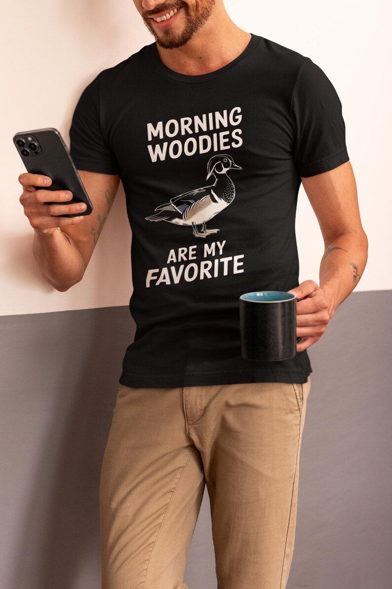 May include: A black t-shirt with a white graphic of a wood duck and the text "Morning Woodies Are My Favorite".