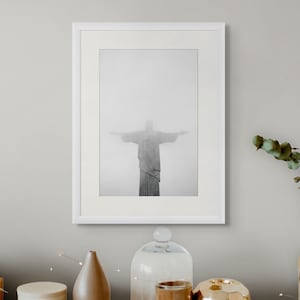 May include: A black and white photograph of the Christ the Redeemer statue in Rio de Janeiro, Brazil. The statue is partially obscured by fog.