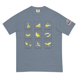 May include: A light blue t-shirt with a graphic of nine bananas in different positions, each labeled with a different alignment from the Dungeons & Dragons alignment chart. The text on the shirt reads: "Lawful Good, Neutral Good, Chaotic Good, Lawful Neutral, True Neutral, Chaotic Neutral, Lawful Evil, Neutral Evil, Chaotic Evil."