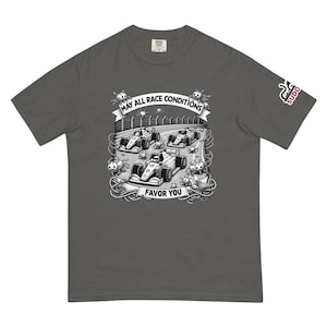 May include: A dark gray t-shirt with a graphic of three race cars on a track with the text "May all race conditions favor you". The graphic also includes small cartoon bugs. The t-shirt has a small logo on the right sleeve that says "SUDO".