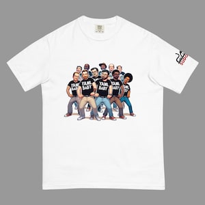 May include: White t-shirt with a cartoon illustration of a group of people wearing black shirts with the text "YAML BABY" printed on them.