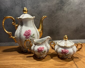 Vintage porcelain set: coffee pot, milk jug, sugar bowl