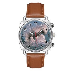 May include: A wristwatch with a brown leather strap and a silver-toned square case. The watch face features a blue background with a white, web-like abstract pattern, black numerals from 1 to 12, and silver hour and minute hands with a red second hand.