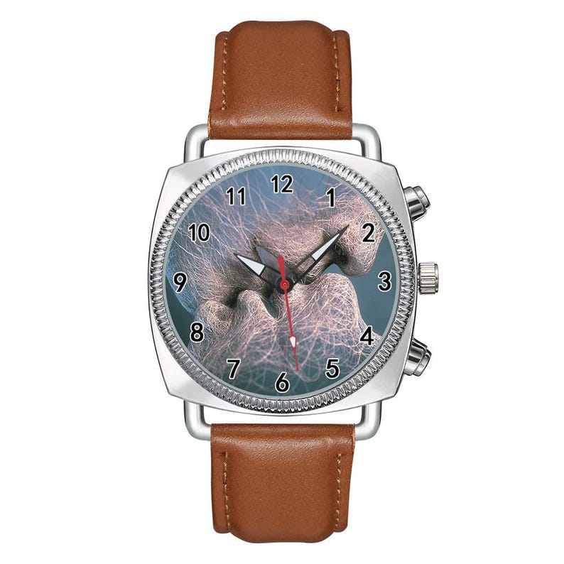 May include: A wristwatch with a brown leather strap and a silver-toned square case. The watch face features a blue background with a white, web-like abstract pattern, black numerals from 1 to 12, and silver hour and minute hands with a red second hand.