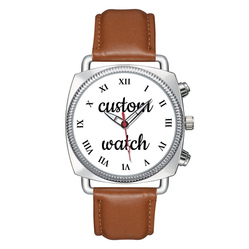 May include: A wristwatch with a silver square case, a white dial featuring black Roman numerals, and the text "custom watch" in black script. The watch has silver hour, minute, and red second hands, and a smooth brown leather strap.