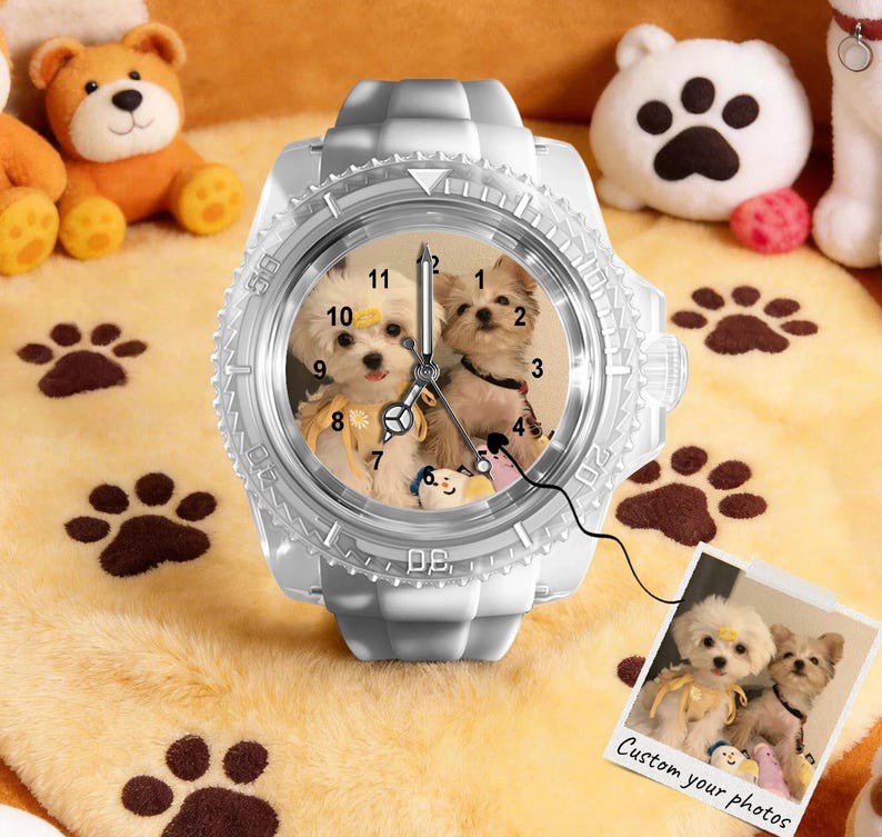 May include: A white analogue wristwatch featuring a custom dial with a photograph of two small dogs. The watch has a textured bezel and a silicone strap. A small square print showing the same dog photograph with the text Custom your photos is attached.
