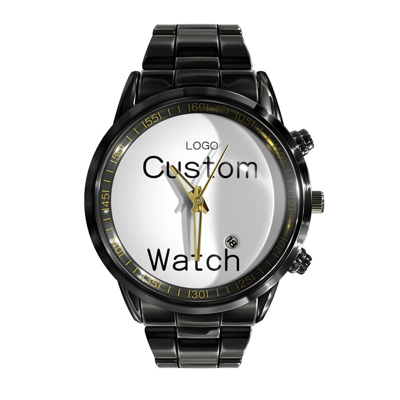 May include: A black metal wristwatch with a white dial featuring the text "LOGO Custom Watch" in black lettering. The watch has gold-toned hands, a date window at the four o'clock position, and a black link bracelet with a polished finish.