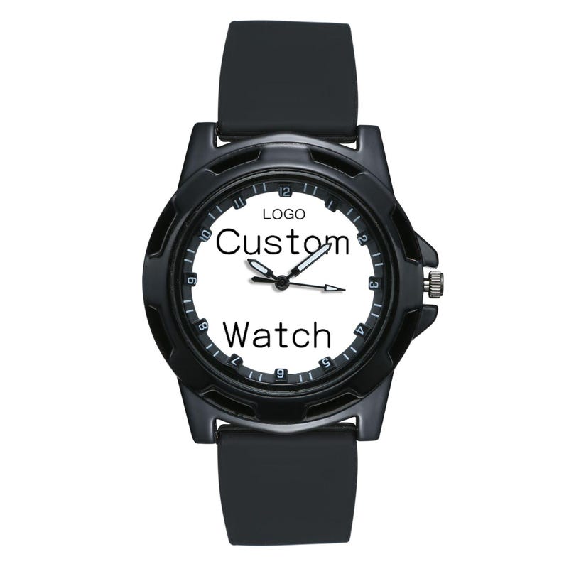 May include: A black wristwatch with a white face featuring the text "LOGO", "Custom", and "Watch". The watch has a black silicone strap, a black circular bezel with numerical hour markers, and three central hands for indicating time.