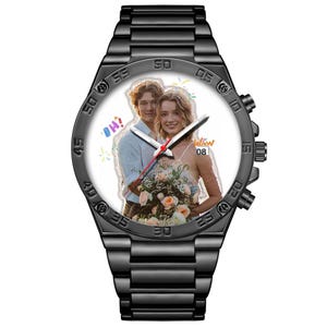 May include: A black metal wristwatch with a link band and a white watch face featuring a custom photograph of a couple holding a bouquet of flowers. The watch face includes white hour and minute hands, a red second hand, and the text OH! and 08.