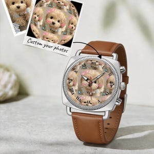 May include: A wristwatch with a brown leather strap and a silver square case. The watch face features a custom collage of a small, light-colored puppy with pink cheeks and blue accents. The text Custom your photos appears above the watch.