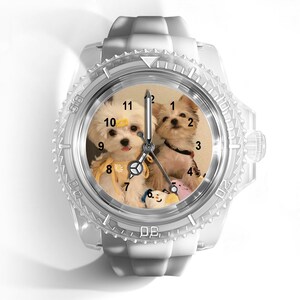 May include: A wristwatch with a translucent white silicone strap and a matching bezel. The watch face features a custom photographic print of two small dogs, one white and one tan, with black hour numerals and silver-toned hour, minute, and second hands.