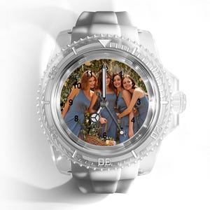 May include: A wristwatch with a translucent white silicone strap and a matching bezel. The watch face features a custom photograph of four people in blue dresses standing together, with black hour markers and silver hands indicating the time.