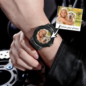 May include: A black analog wristwatch featuring a custom photo dial that displays a person hugging a golden retriever. The watch has a black silicone strap and a round black bezel. A small inset photo shows the same image with the text Custom your photos.