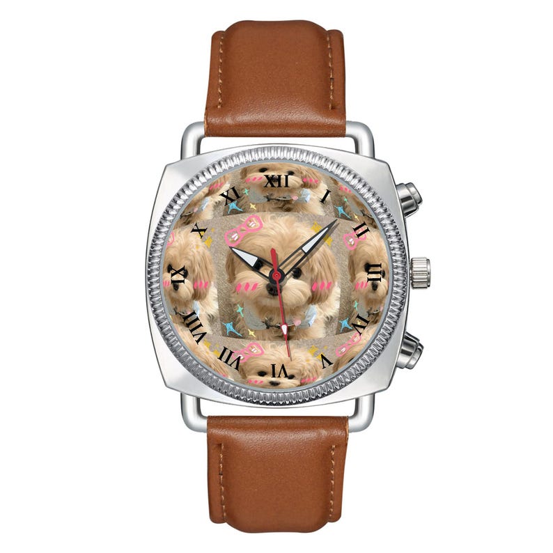 May include: A silver-toned wristwatch with a brown leather strap. The watch face features a repeating pattern of a light-colored puppy with pink cheeks and small pink bows, overlaid with black Roman numerals and three thin black and red hands.