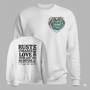 May include: White sweatshirt with the text "RUST COLLEGE LOVE" on the back and a heart-shaped logo with "Rust College" and "World is full of colleges" on the front. The sweatshirt also has the text "NONE LIKE YOU SO DIVINE 18 ROYAL WHITE AND BLUE 66".