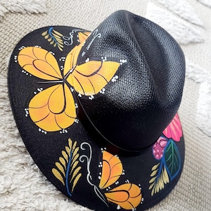 Black straw hat with monarch Butterfly and vibrant multi color flowers