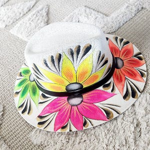 White straw hat with multi color flowers black and gold accents