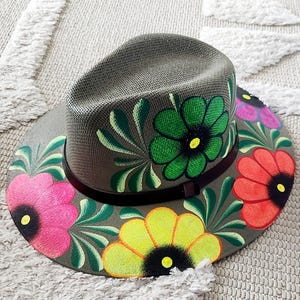 Olive straw hat with vibrant multi color flowers