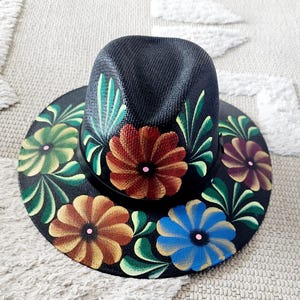 Black straw hat with multi color flowers and green accents