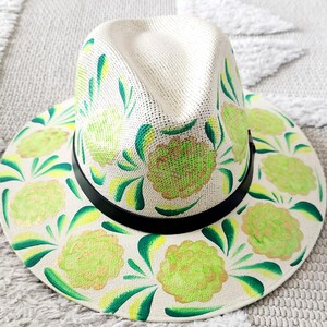 Beige sraw hat with neon chartreuse flowers and green and gold accents