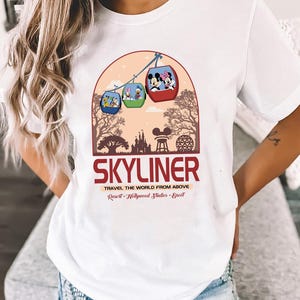 a woman wearing a white skyliner t - shirt