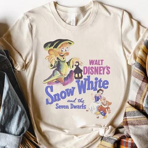 a t - shirt with snow white and seven dwarfs on it